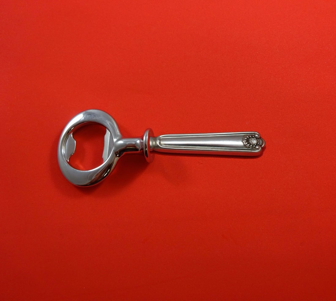 Frank Smith Fiddle Shell Sterling Silver 6in Bottle Opener: Frank Smith Fiddle Shell Sterling Silver 6in Bottle Opener Sterling silver bottle opener in the Fiddle Shell pattern by Frank Smith. It features a sterling silver hollow handle with a chrome plated im