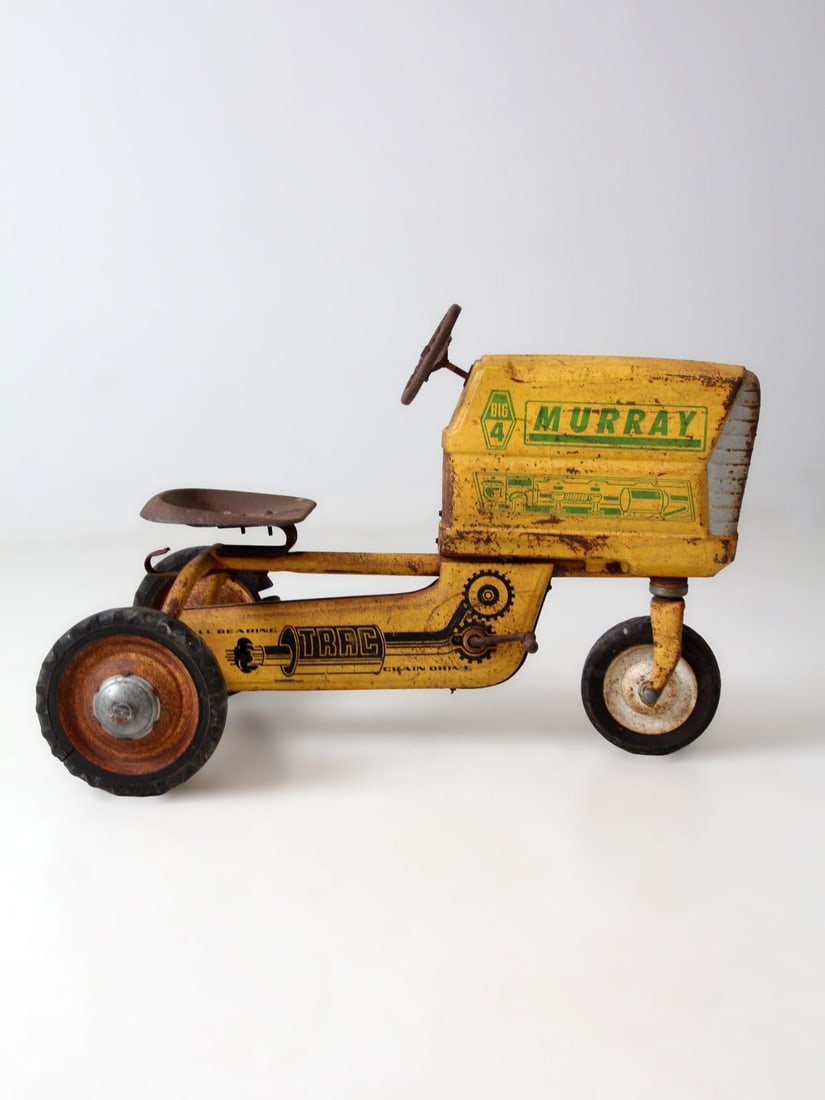 Vintage 1950s Murray Big 4 Yellow Pedal Tractor with Original Graphics: Vintage 1950s Murray Big 4 Yellow Pedal Tractor with Original Graphics This late 1950s Murray Big 4 pedal tractor features a pressed steel body with a curved hood, sculpted seat, and wide stance, high
