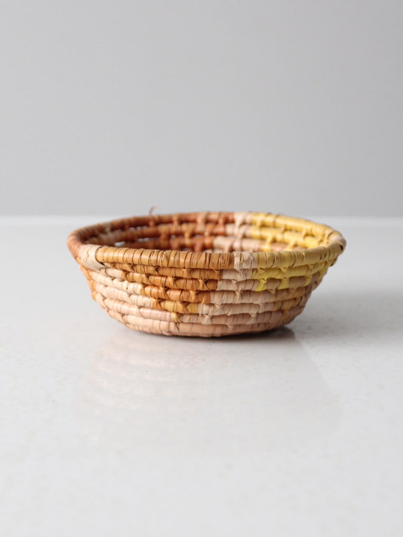 Vintage Coiled Basket Bowl in Warm Tan and Honey Tones: Vintage Coiled Basket Bowl in Warm Tan and Honey Tones This mid-century coiled basket bowl features a low, open form and is finished in warm tan, honey, and soft yellow tones. Its spiral construction 