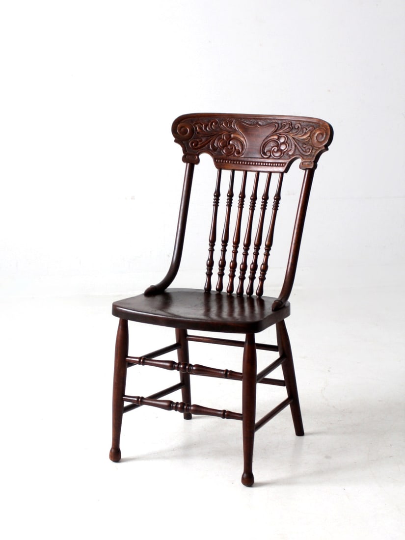 Charming Antique Pressed Back Dining Chair with Spindle Back: Charming Antique Pressed Back Dining Chair with Spindle Back Discover this charming antique pressed back dining chair, crafted with a beautifully turned spindle back and a decoratively pressed back to