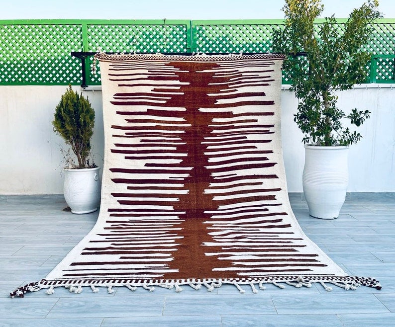 Handmade Moroccan Berber Wool Area Rug 9.84 x 6.56 Feet: Handmade Moroccan Berber Wool Area Rug 9.84 x 6.56 Feet Enhance your space with this stunning Handmade Moroccan Berber Wool Area Rug. Crafted by local Berber women weavers in the Atlas Mountains, this