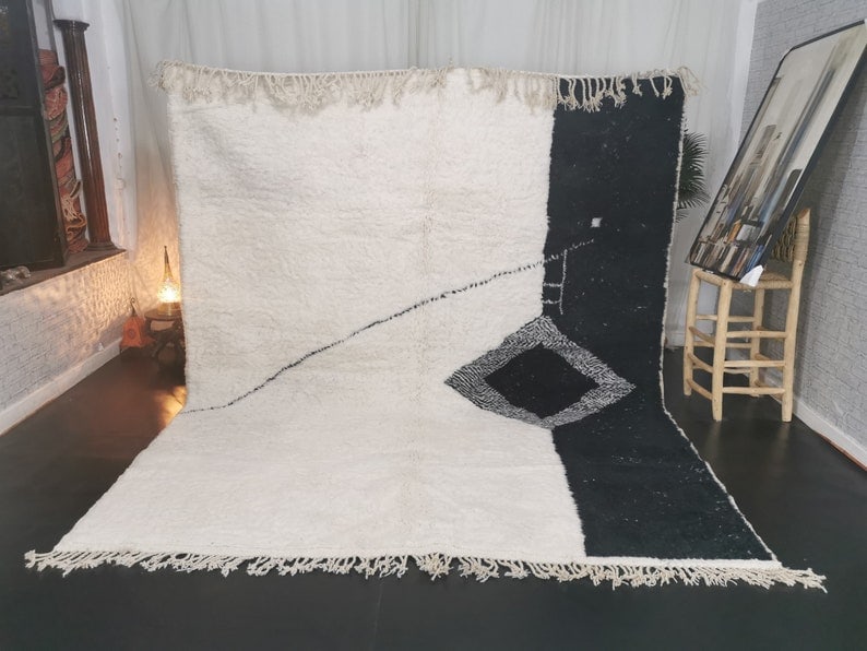 Handmade Black and White Wool Rug from Morocco 9.84 x 6.56 Feet: Handmade Black and White Wool Rug from Morocco 9.84 x 6.56 Feet Introducing a stylish black and white rug, handwoven from 100% local sheep wool. Crafted by skilled Berber women weavers in the Middle A
