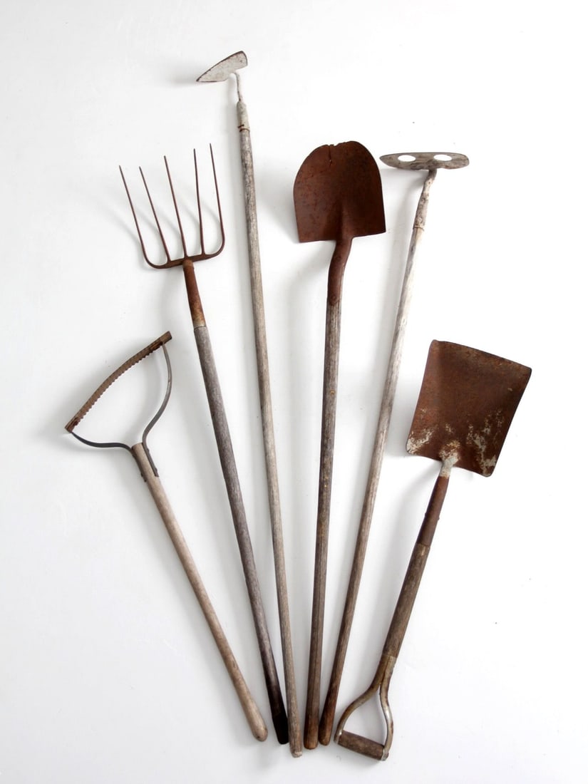 Set of 6 Early 20th Century Rustic Farm Garden Tools: Set of 6 Early 20th Century Rustic Farm Garden Tools A collection of six early 20th century primitive garden tools with weathered wood handles and aged iron heads. The assortment includes a pitchfork,