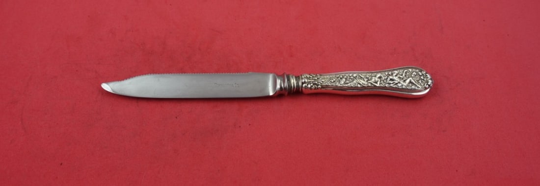 Tiffany & Co Olympian Sterling Silver Serrated Fruit Knife 7.5": Tiffany & Co Olympian Sterling Silver Serrated Fruit Knife 7.5" This exquisite fruit knife from Tiffany & Co. features the elegant Olympian pattern and is crafted from sterling silver with a hollow ha