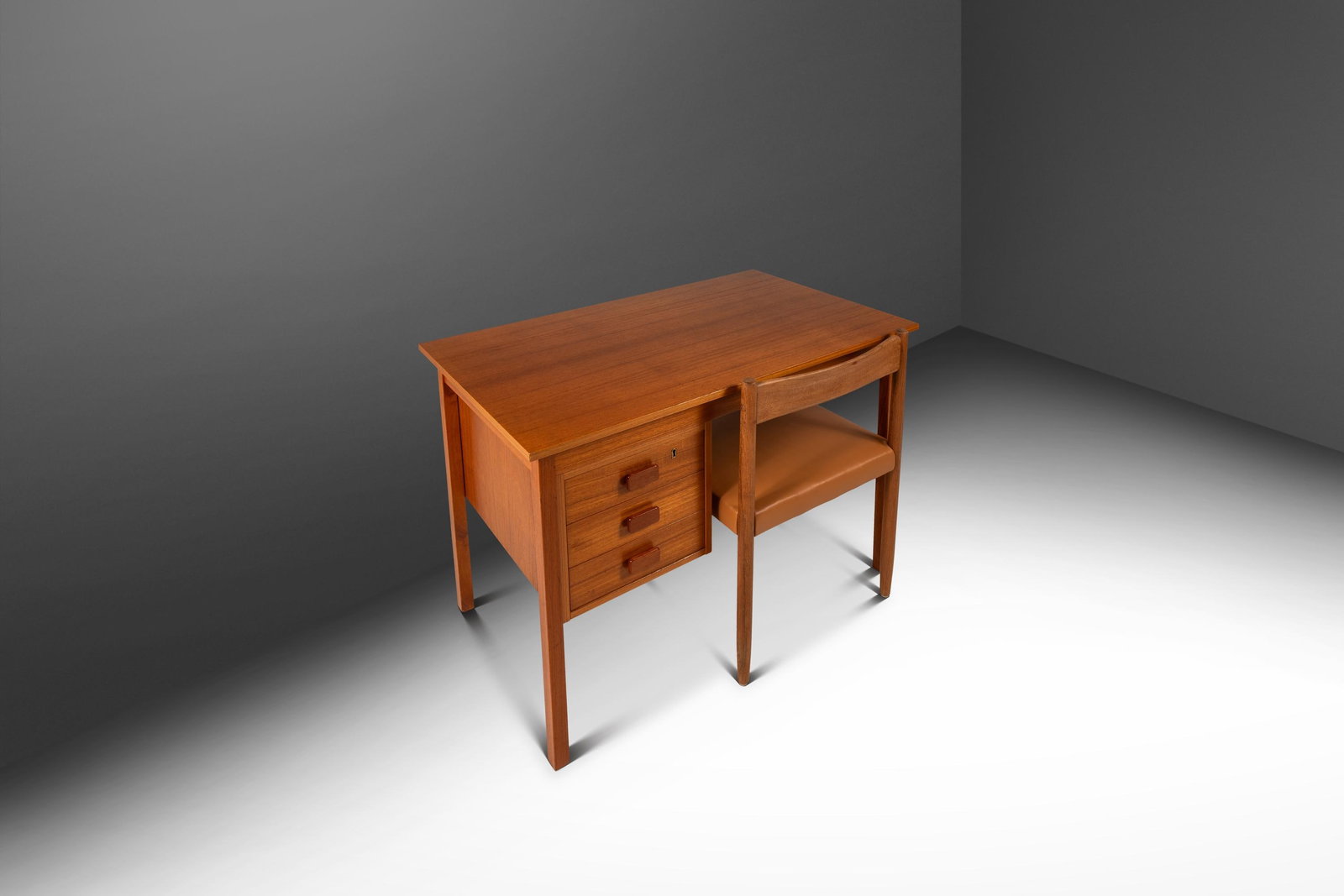 Teak Petite Danish Writer Desk by Faarup Mobelfabrik: Teak Petite Danish Writer Desk by Faarup Mobelfabrik This Danish Mid-Century Modern petite writer's desk, attributed to Ib Kofod-Larsen and produced by Faarup Mobelfabrik in the 1980s, is crafted from