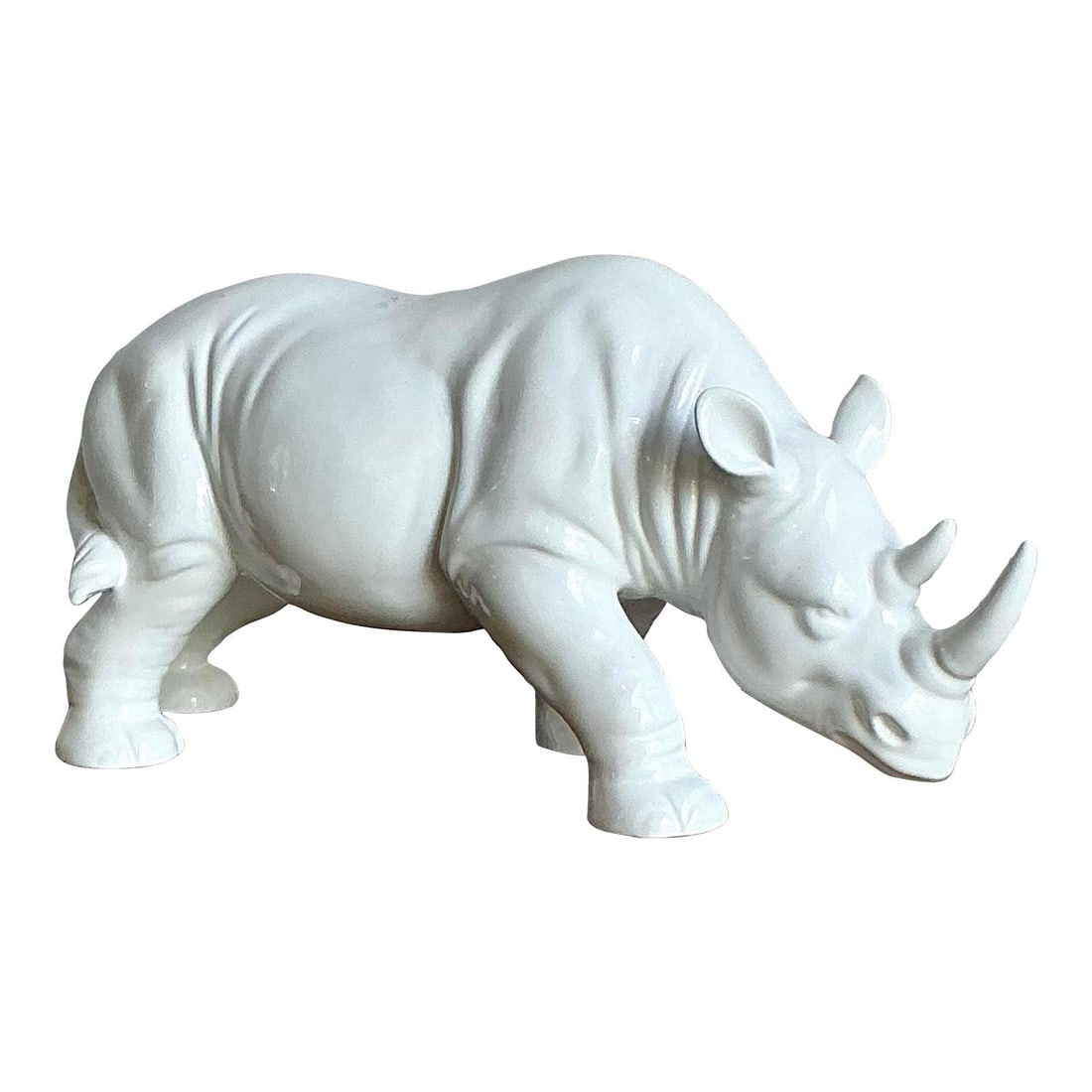 White Glazed Porcelain Rhinoceros Sculpture Mid-Century Modern Accent 17.75": White Glazed Porcelain Rhinoceros Sculpture Mid-Century Modern Accent 17.75" This vintage rhinoceros figurine is crafted from high-gloss white ceramic, showcasing clean lines and a sculptural presence