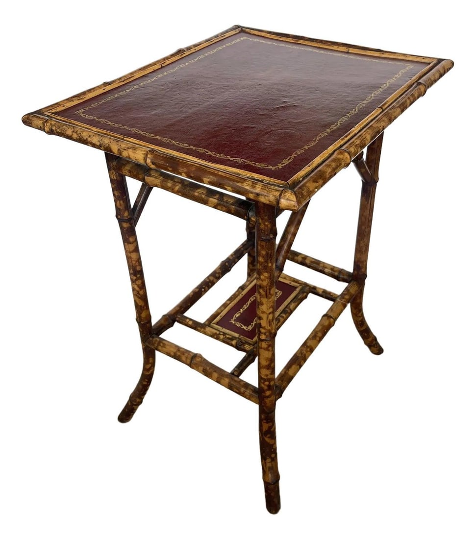 19th Century French Tortoiseshell Bamboo Table with Red Leather Top: 19th Century French Tortoiseshell Bamboo Table with Red Leather Top This elegant French 19th Century Tortoiseshell Bamboo Table showcases a stunning two-tier design, complemented by a rich red tooled 