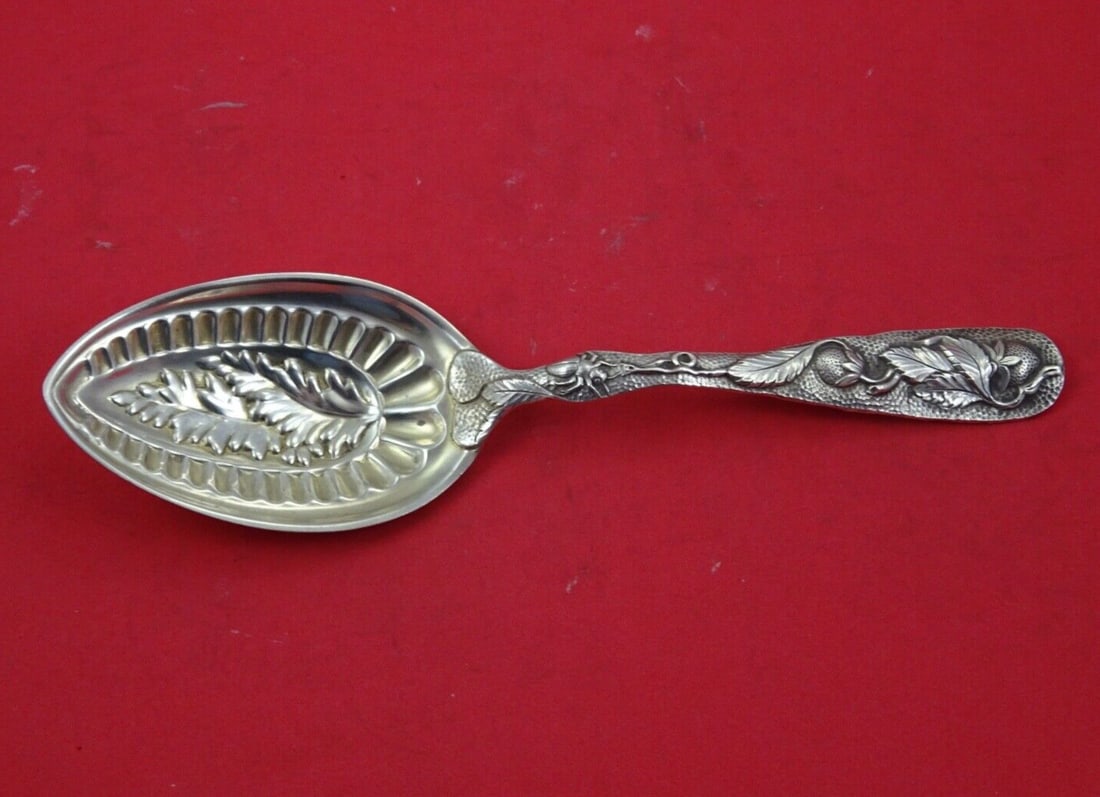 Duhme Strawberry Pattern Sterling Silver Berry Spoon 9 1/4": Duhme Strawberry Pattern Sterling Silver Berry Spoon 9 1/4" This exquisite Strawberry pattern berry spoon, crafted in sterling silver by Duhme, features intricate detailing of a bug and strawberry on 