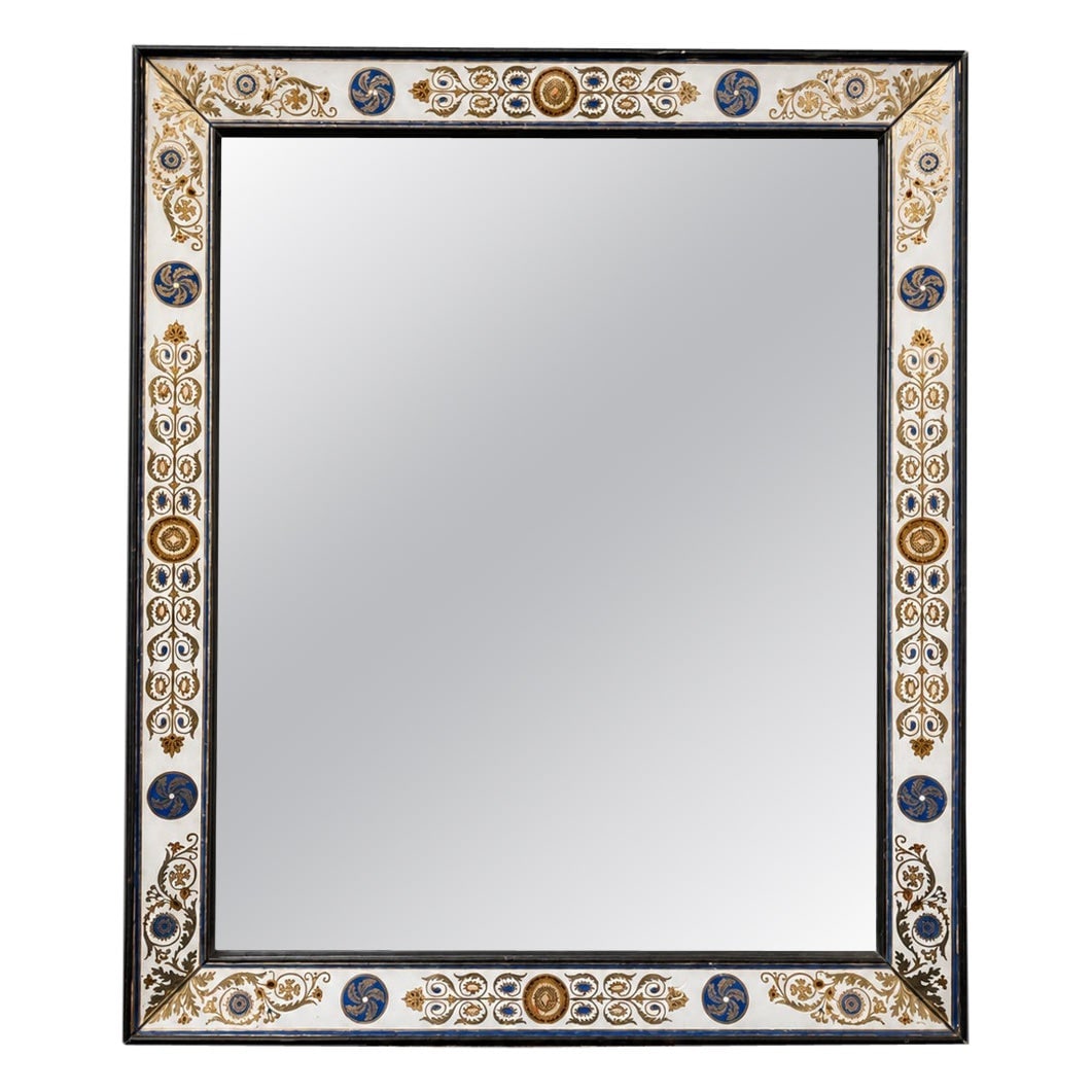 French Charles X verre eglomise wall mirror circa 1860: French Charles X verre eglomise wall mirror circa 1860 This is a finely crafted French Charles X style verre eglomise mirror from circa 1860. The mirror features a rectangular frame bordered by revers