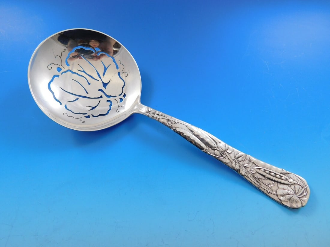 Tiffany and Co Vine Sterling Silver Slotted Pea Spoon 9 1/8 in: Tiffany and Co Vine Sterling Silver Slotted Pea Spoon 9 1/8 in A Tiffany & Co. Vine pattern sterling silver slotted pea spoon featuring a peapod motif on the handle. The piece is 9 1/8 inches long, is