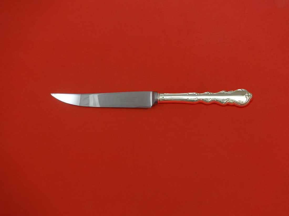 Custom Angelique International Sterling Steak Knife 8 1/2 HHWS: Custom Angelique International Sterling Steak Knife 8 1/2 HHWS A custom-made steak knife in the Angelique pattern by International. It features a sterling silver hollow handle with a stainless impleme