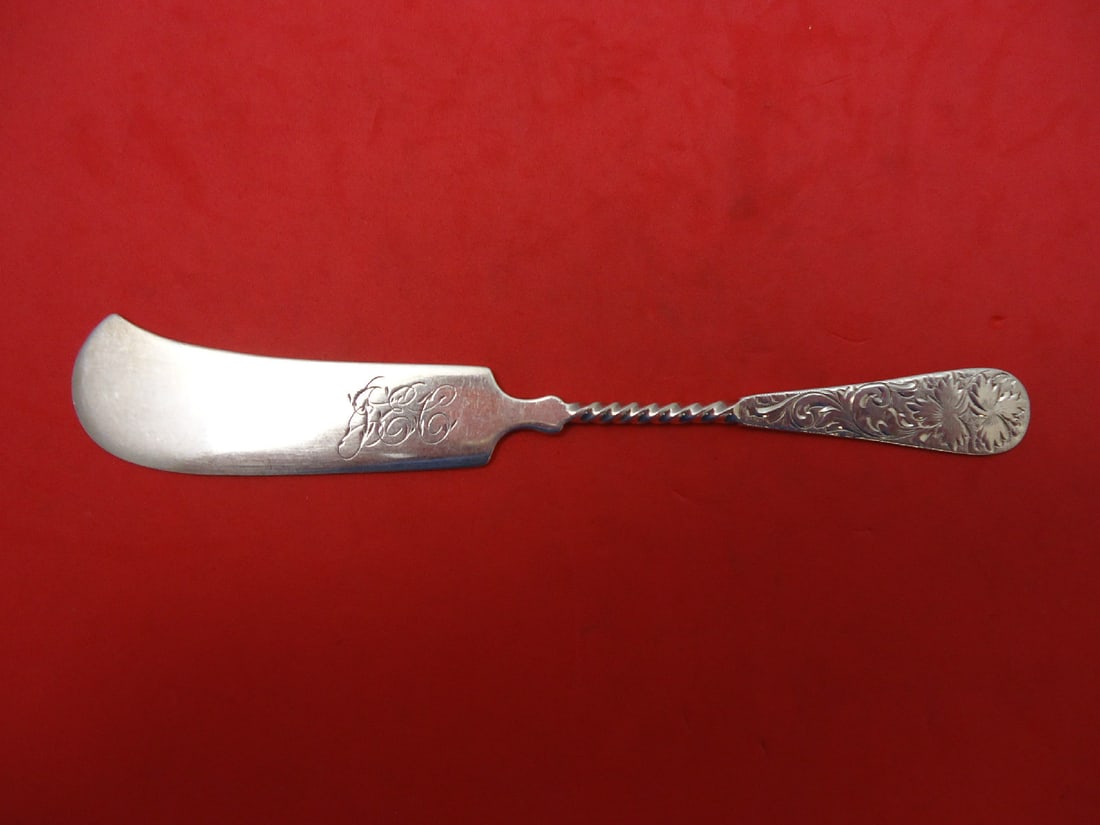 Sterling Silver Brite Cut Butter Spreader Twist Handle 5 5/8 Inch: Sterling Silver Brite Cut Butter Spreader Twist Handle 5 5/8 Inch This exquisite butter spreader features a twist handle design and is crafted from high-quality sterling silver. The piece showcases a 