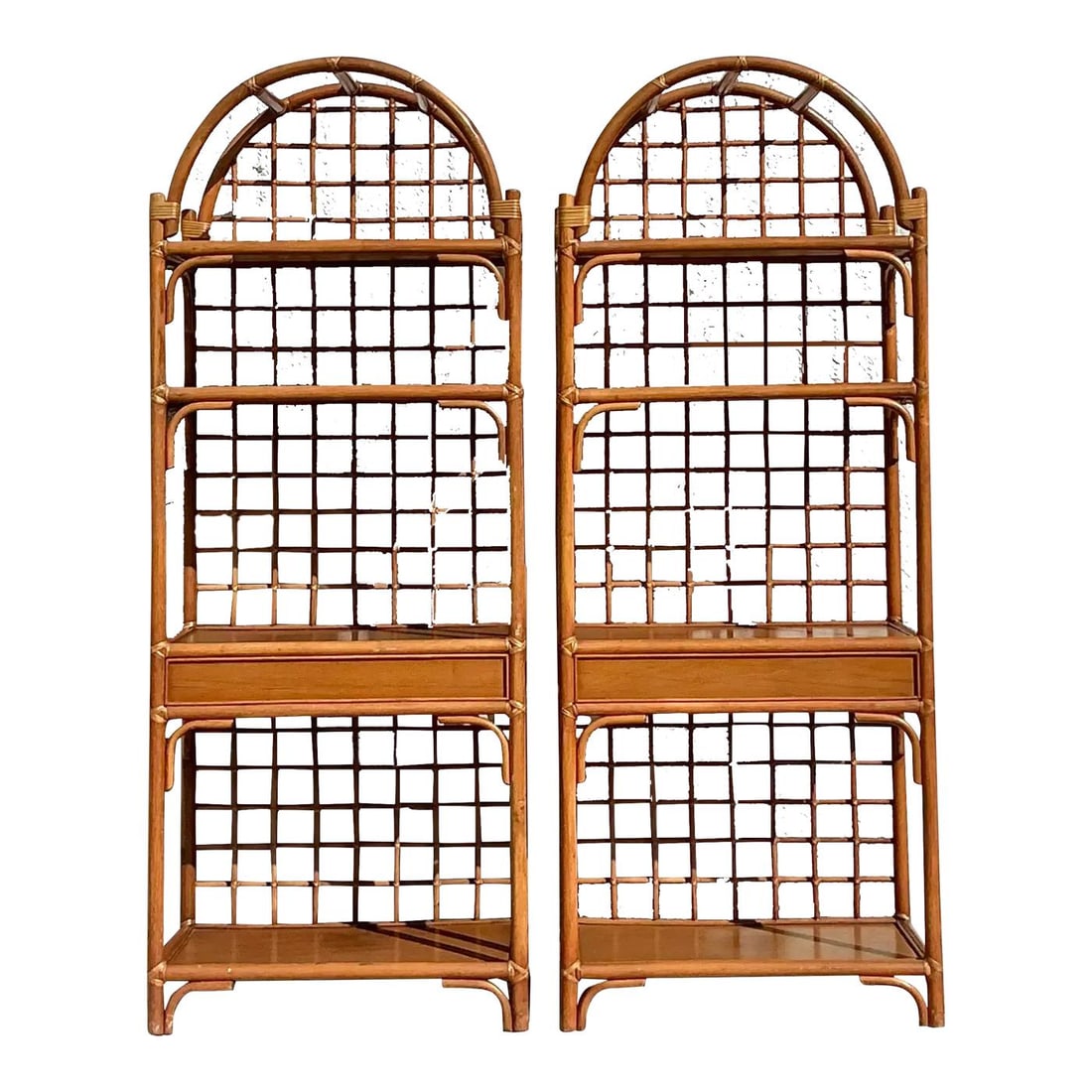 Pair of Vintage Rattan Etagere with Coastal Charm: Pair of Vintage Rattan Etagere with Coastal Charm Enhance your living space with this exquisite pair of vintage coastal grid rattan etageres. Showcasing a graceful arched silhouette and intricate grid