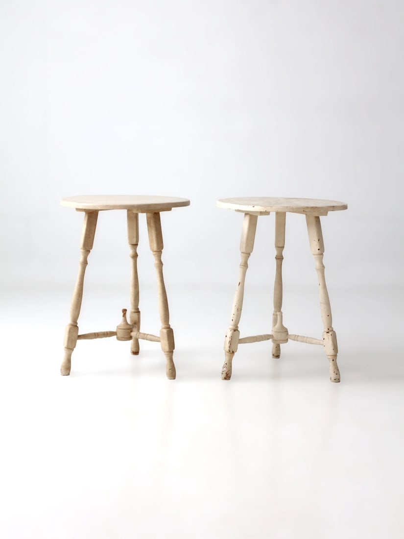 Pair of Vintage Painted Pedestal Side Tables 20 inch: Pair of Vintage Painted Pedestal Side Tables 20 inch A pair of vintage pedestal side tables with softly layered cream paint, turned spindle legs, and small round tops. The worn painted finish and hand
