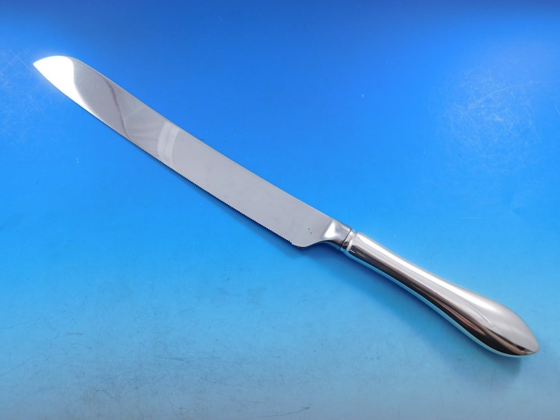 Dominick & Haff Sterling Silver Pointed Antique Wedding Cake Knife 11": Dominick & Haff Sterling Silver Pointed Antique Wedding Cake Knife 11" This exquisite wedding cake knife, crafted by Dominick & Haff, showcases the elegant Pointed Antique pattern. Made from high-qual
