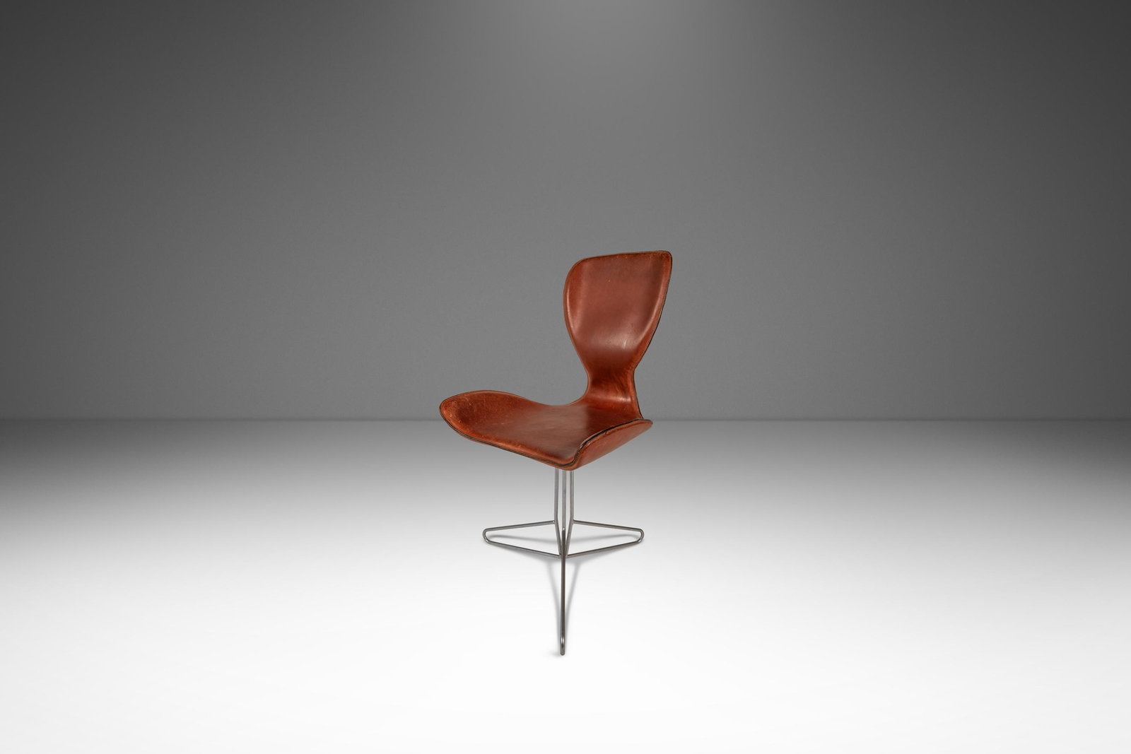K2 Swivel Office Chair by Kirsten Jones and Adam Bottomley for KOI Patinaed Leather: K2 Swivel Office Chair by Kirsten Jones and Adam Bottomley for KOI Patinaed Leather This rare K2 office swivel chair, designed by Kirsten Jones and Adam Bottomley for KOI in the 2000s, draws inspirati