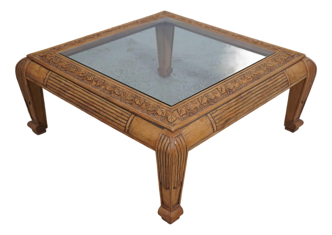 Traditional Carved Wood Coffee Table with Glass Top: Traditional Carved Wood Coffee Table with Glass Top This exquisite square cocktail coffee table features a stunning traditional design complemented by fine carved details and a carved grapevine motif.