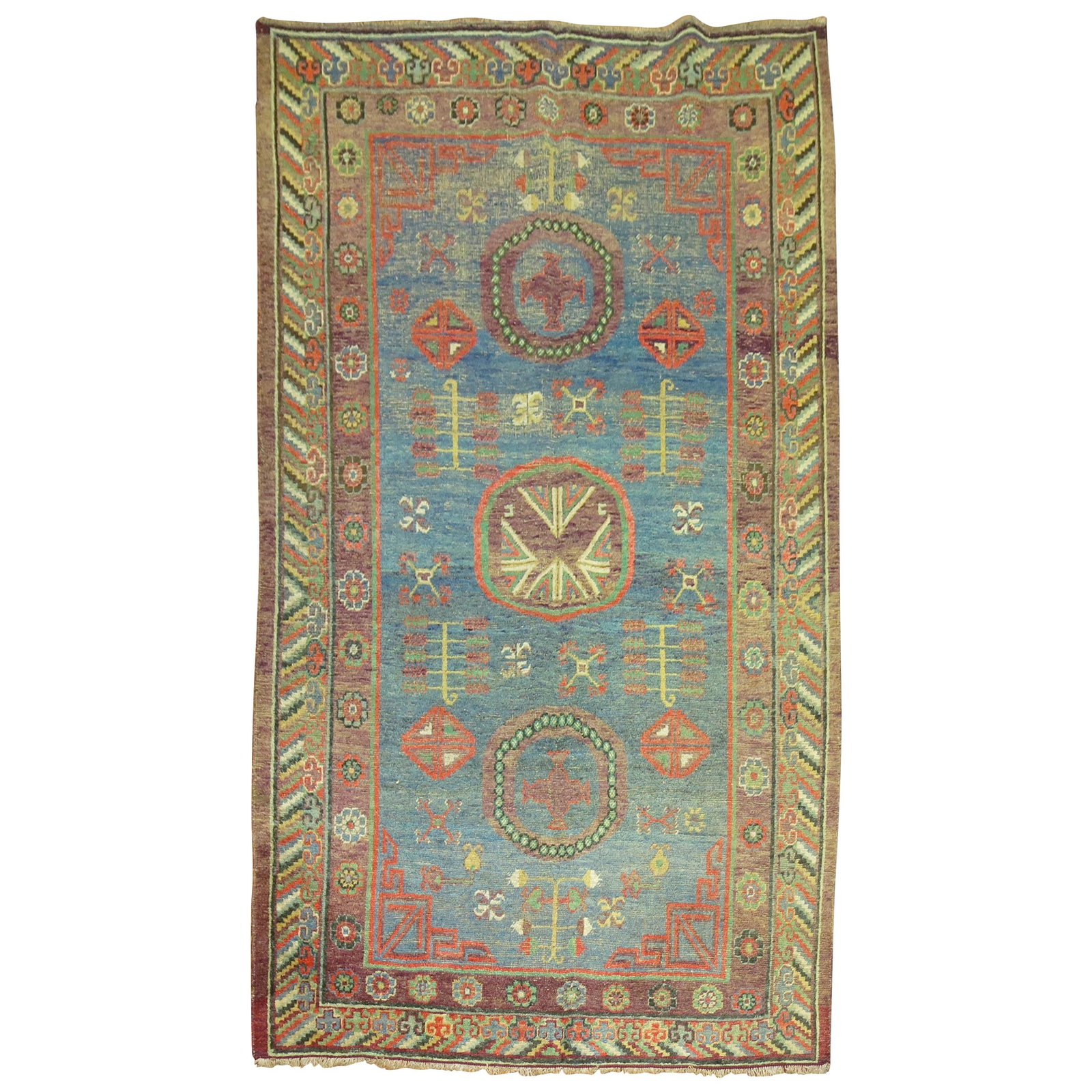 Antique Khotan Rug Denim Blue Hand-Woven Early 20th Century 63 x 105: Antique Khotan Rug Denim Blue Hand-Woven Early 20th Century 63 x 105 Discover the charm of this early 20th century Khotan antique rug, featuring a whimsical denim blue field enriched with stylized geo