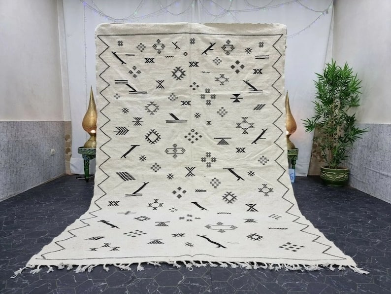 Handwoven White Moroccan Rug 100% Sheep Wool 8 x 5 Feet: Handwoven White Moroccan Rug 100% Sheep Wool 8 x 5 Feet Enhance your space with this Lovely White Authentic Rug, meticulously handwoven in the Atlas Mountains by local Berber women weavers. Crafted us