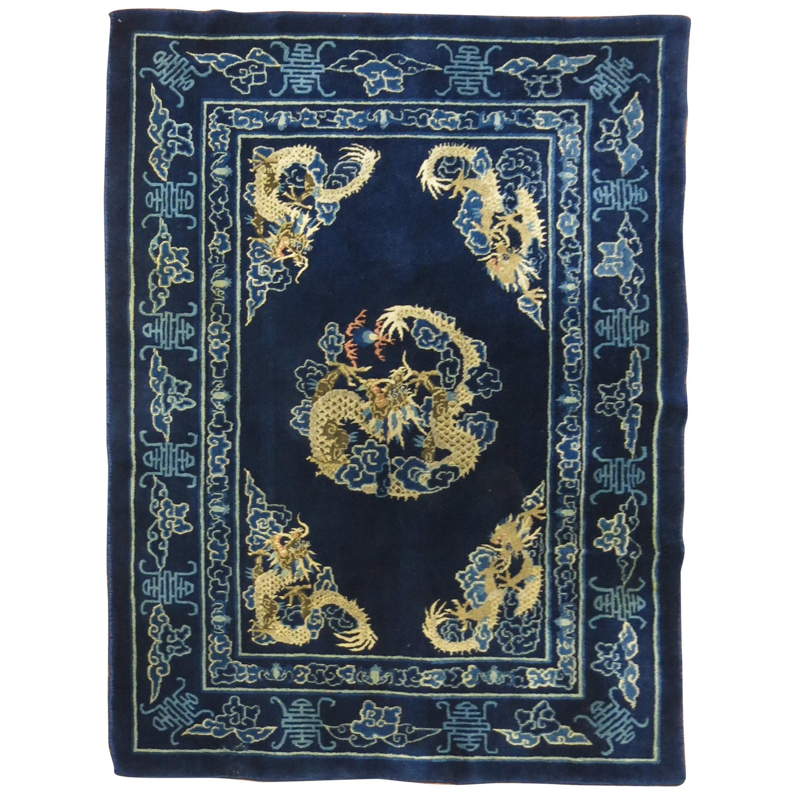 Expressionist Tibetan Wool Dragon Rug 4'1 x 6'1: Expressionist Tibetan Wool Dragon Rug 4'1 x 6'1 This mid-20th century Chinese rug features an expressionist design with four dragons floating on a navy blue ground. Hand-knotted from wool, it has a fu