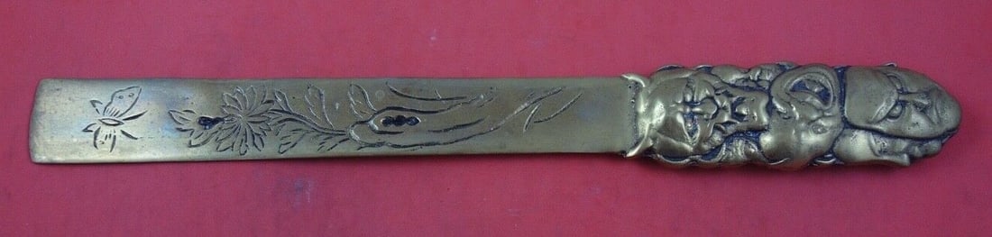 Bronze Japanese Page Turner Featuring Faces and Butterfly Motif 11 Inch: Bronze Japanese Page Turner Featuring Faces and Butterfly Motif 11 Inch This Japanese bronze page turner features decorative faces and a butterfly motif. Crafted in Japan by an unknown maker, it measu
