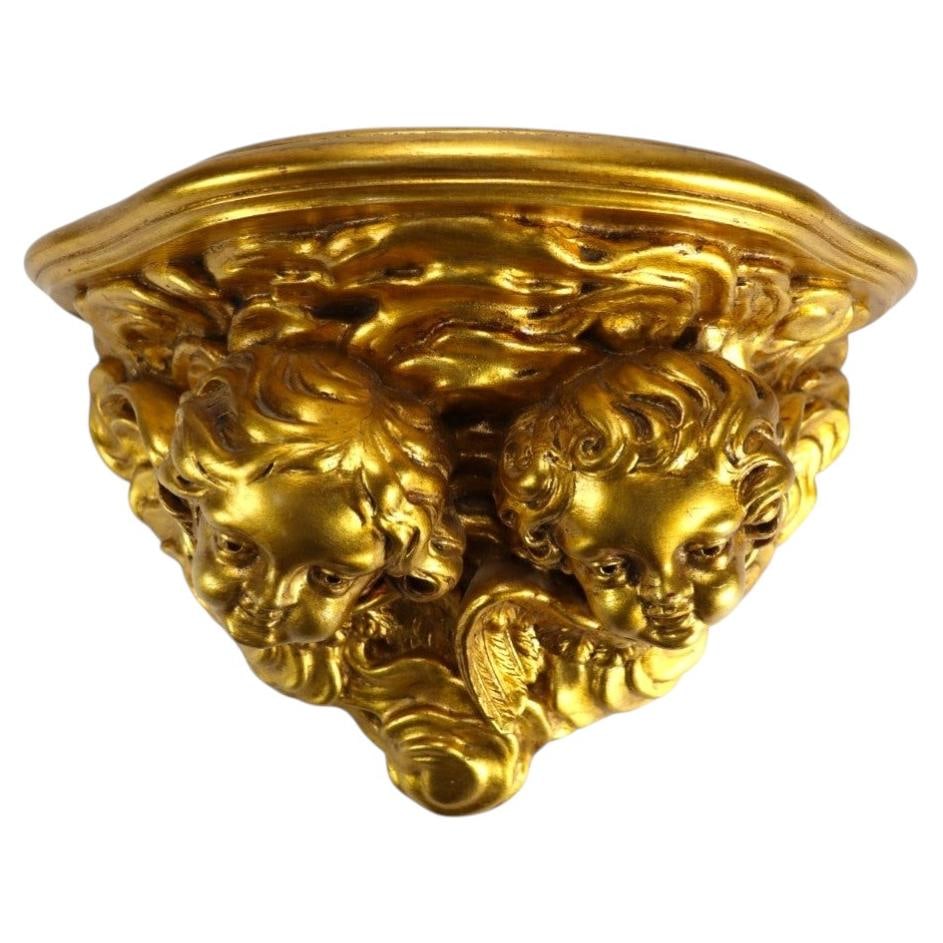 Italian giltwood cherub wall sconce Niccolini c1950: Italian giltwood cherub wall sconce Niccolini c1950 This vintage Italian wall sconce, attributed to the Niccolini workshop and dating to circa 1950, is crafted from giltwood. The piece features two fi