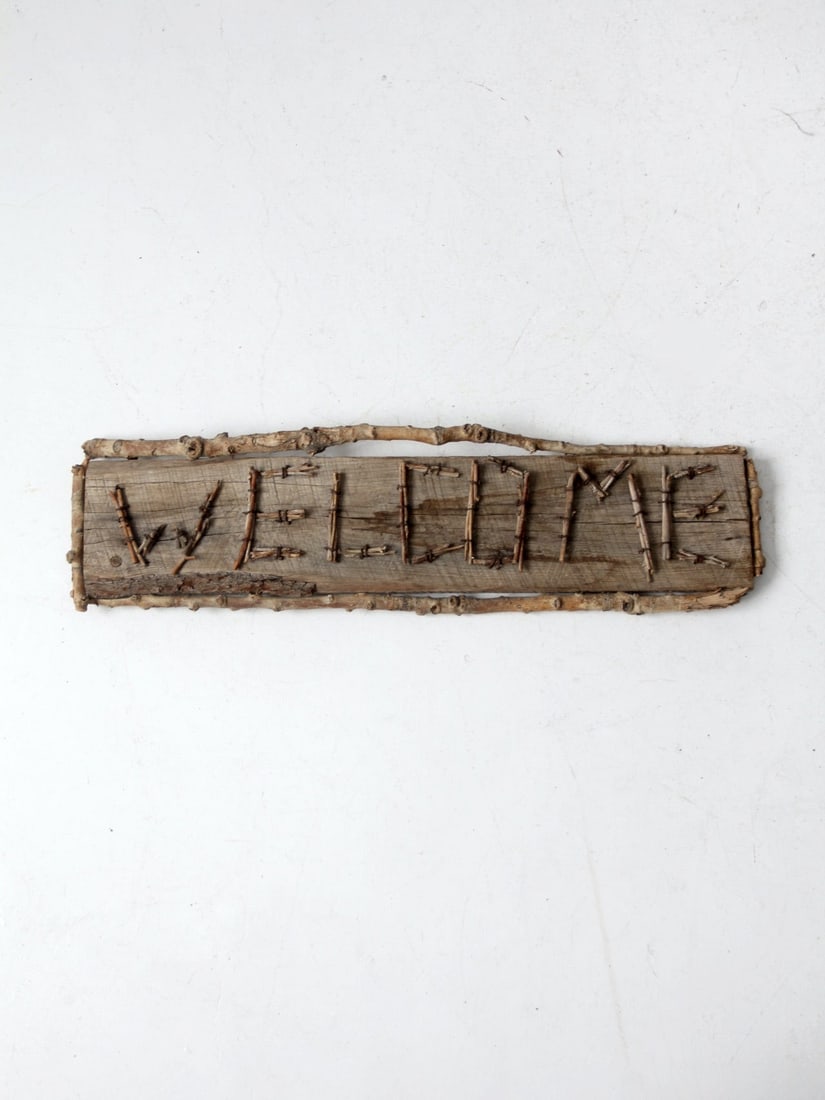 Charming Vintage Rustic Welcome Sign with Branch Frame: Charming Vintage Rustic Welcome Sign with Branch Frame This charming vintage rustic "Welcome" sign features a rough hewn board design, beautifully framed with branches and twigs that form the letterin