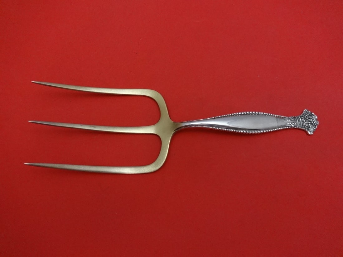 Shiebler Sandringham Sterling Silver Gold Washed Toast Fork 7 1/8": Shiebler Sandringham Sterling Silver Gold Washed Toast Fork 7 1/8" This exquisite serving fork from the Sandringham pattern by Shiebler is crafted from sterling silver and features a gold wash for an 