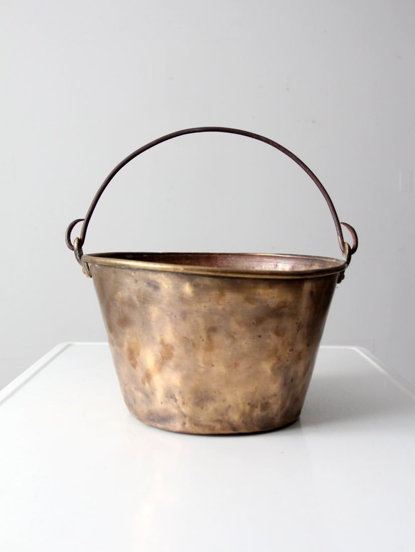 19th Century Antique Brass Fire Bucket with Iron Handle: 19th Century Antique Brass Fire Bucket with Iron Handle This antique brass fire bucket dates back to the mid to late 19th century, showcasing a classic design with an iron bail handle. The kettle exhi