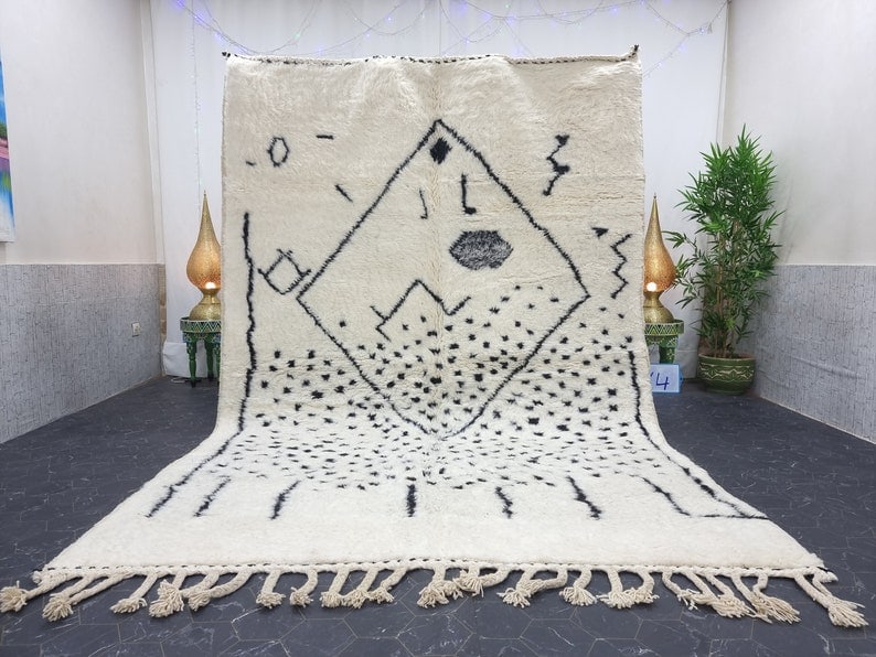 Authentic Handmade Moroccan Berber Wool Rug 9.84 x 6.56 Feet: Authentic Handmade Moroccan Berber Wool Rug 9.84 x 6.56 Feet This exquisite Soft White & Black Handmade Moroccan Berber Wool Area Rug showcases the unique craftsmanship of Berber women weavers from th