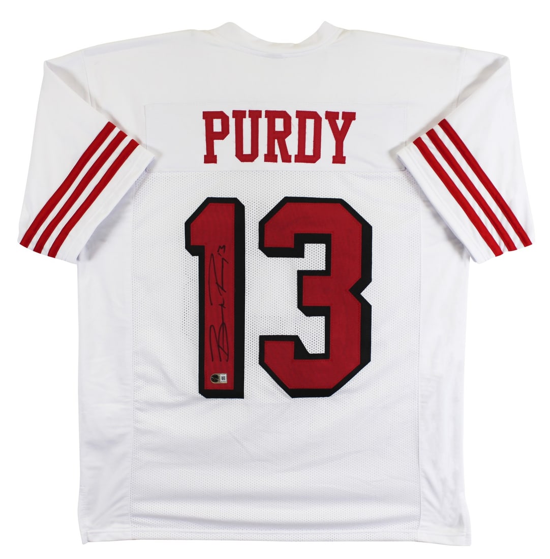 Brock Purdy BAS Witnessed White Pro Style 49ers Jersey: Brock Purdy BAS Witnessed White Pro Style 49ers Jersey This white pro style jersey features a dropshadow design and has been personally signed by Brock Purdy of the San Francisco 49ers. The autograph 