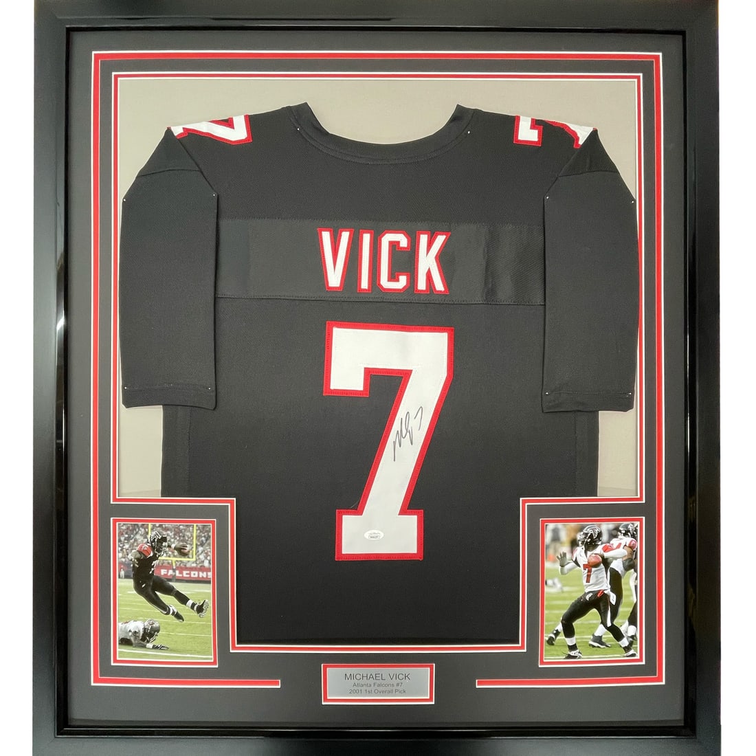 Framed Michael Vick Autographed Atlanta Falcons Jersey with JSA COA 33x42: Framed Michael Vick Autographed Atlanta Falcons Jersey with JSA COA 33x42 This framed autographed jersey features Michael Vick, the iconic quarterback of the Atlanta Falcons. Measuring 33" x 42", the 