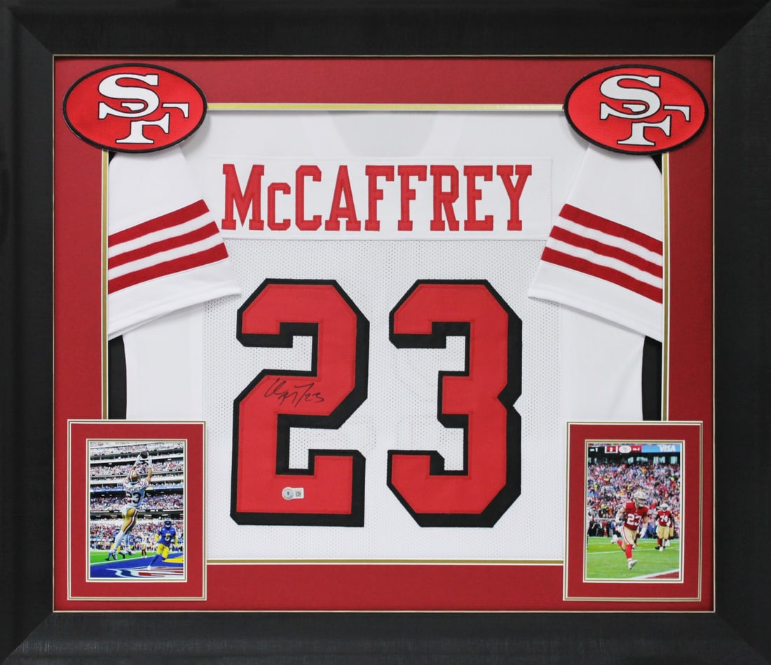 Framed Christian McCaffrey 49ers Signed White Pro Style Jersey BAS: Framed Christian McCaffrey 49ers Signed White Pro Style Jersey BAS This professionally framed white pro style jersey features an authentic hand-signed autograph by Christian McCaffrey of the San Franc
