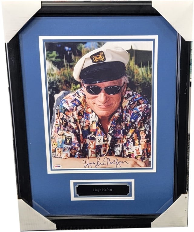 Hugh Hefner Autographed Photo Custom Framed PSA Certified 18 x 24: Hugh Hefner Autographed Photo Custom Framed PSA Certified 18 x 24 This stunning framed photograph features the iconic Hugh Hefner, hand-signed by the Playboy founder himself. The piece is authenticate