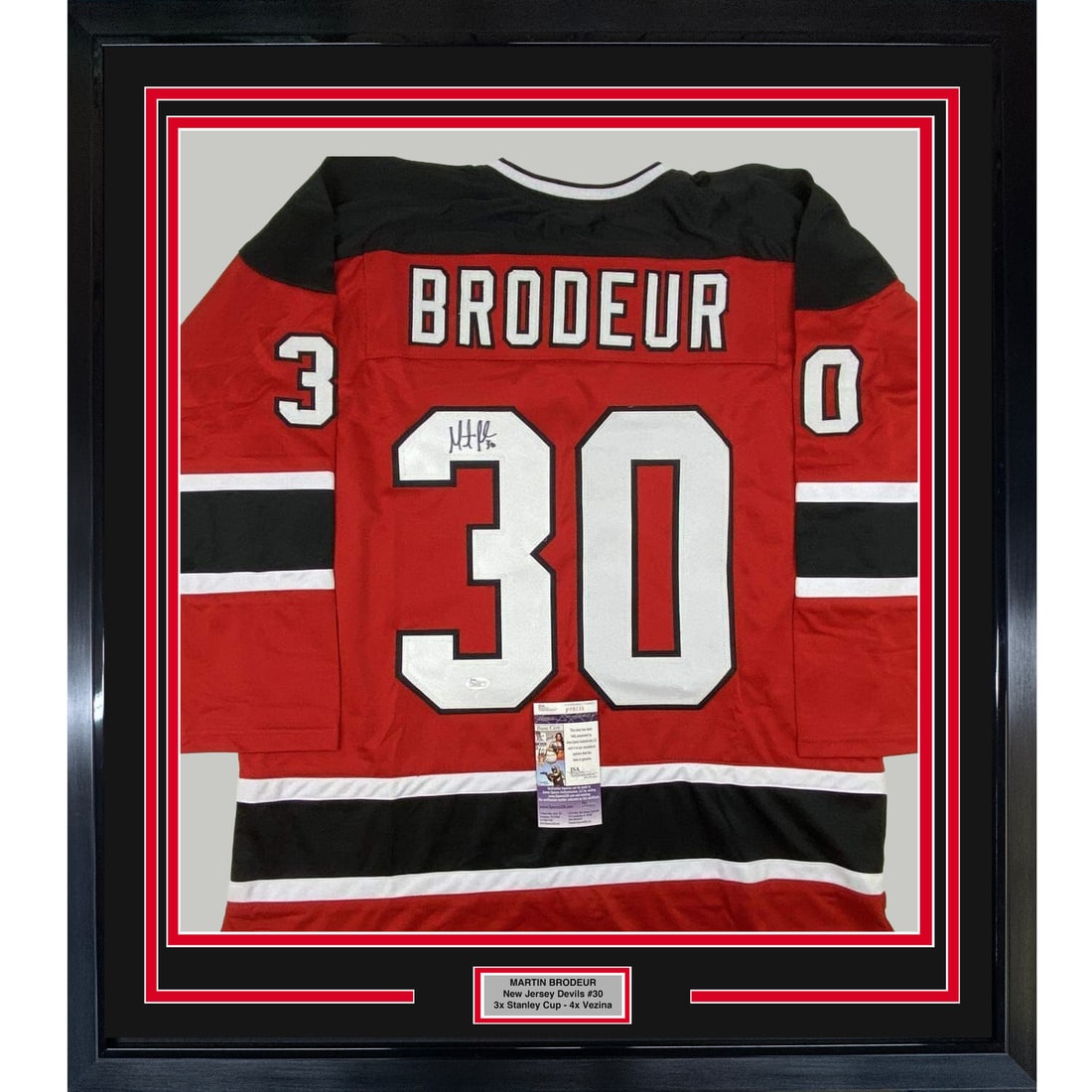 Framed Martin Brodeur signed Devils jersey JSA COA 33x42: Framed Martin Brodeur signed Devils jersey JSA COA 33x42 This professionally framed and matted display features a red New Jersey Devils jersey autographed by Martin Brodeur. The frame includes two 8x1