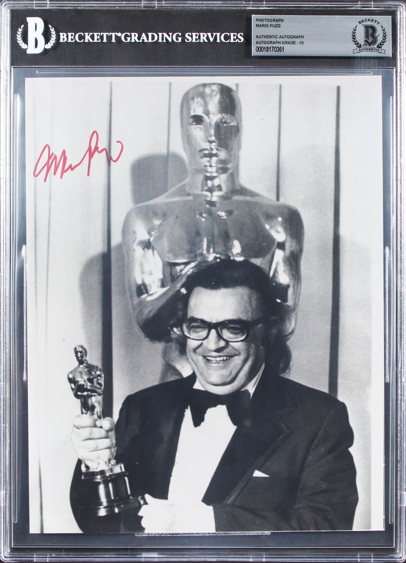 Mario Puzo The Godfather Signed 8x10 Photo BAS Authenticated Gem Mint 10: Mario Puzo The Godfather Signed 8x10 Photo BAS Authenticated Gem Mint 10 This authentic 8x10 photograph, personally signed by Mario Puzo, the renowned author of The Godfather, showcases his iconic sig