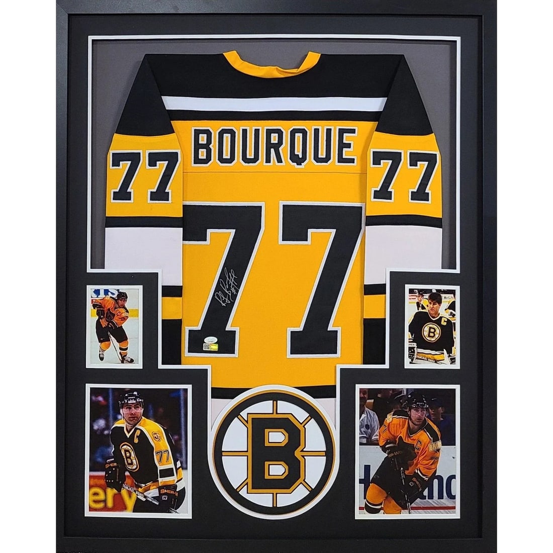 Framed Ray Bourque Autographed Bruins Jersey JSA Authenticated: Framed Ray Bourque Autographed Bruins Jersey JSA Authenticated This framed yellow Boston Bruins jersey is autographed by Ray Bourque and features professional framing with detailed logo work. The jers