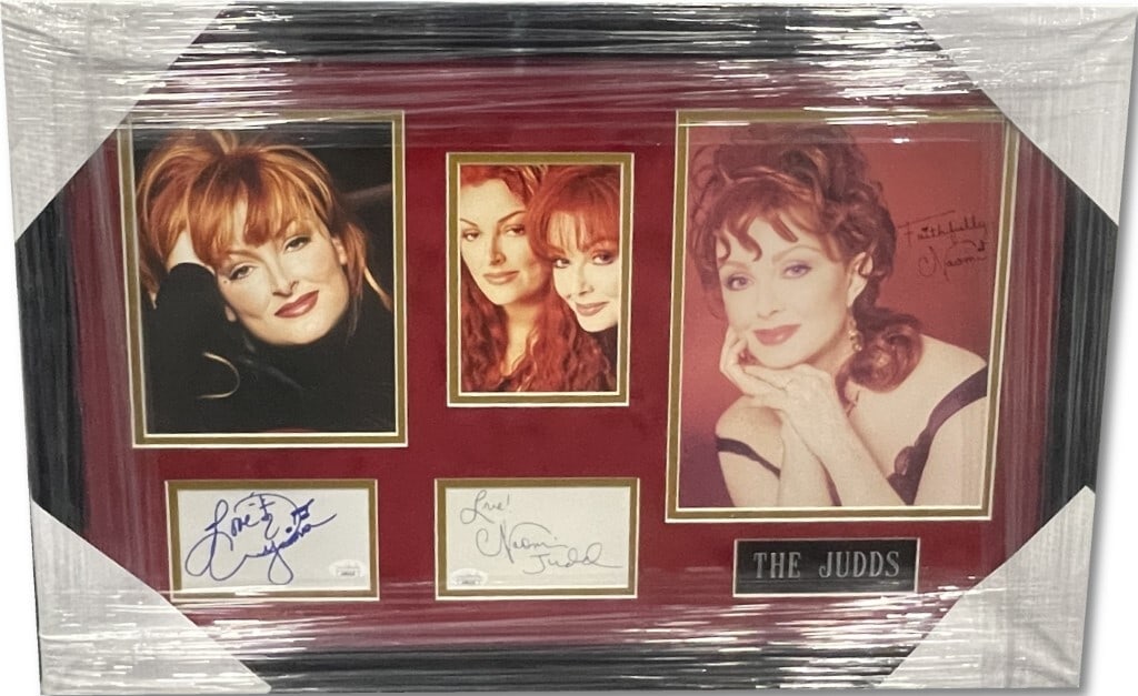 The Judds Autographed Custom Framed 26x17 JSA Certified Naomi Wynonna Judd: The Judds Autographed Custom Framed 26x17 JSA Certified Naomi Wynonna Judd This is an original custom-framed display featuring the autographs of Naomi Judd and Wynonna Judd, members of the iconic duo 