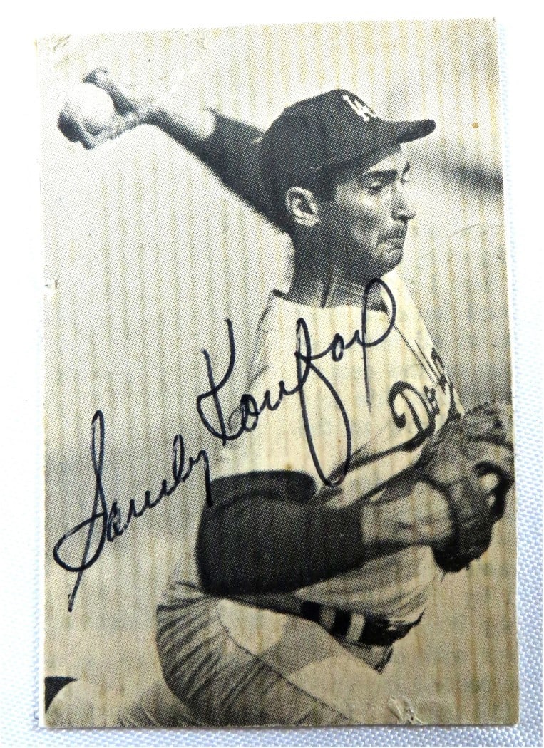 Sandy Koufax Autographed Dodgers Small Photo 2.5x3.75 JSA Certified: Sandy Koufax Autographed Dodgers Small Photo 2.5x3.75 JSA Certified This is a vintage black and white small photo of Sandy Koufax, featuring his authentic autograph. The photograph has been custom cut