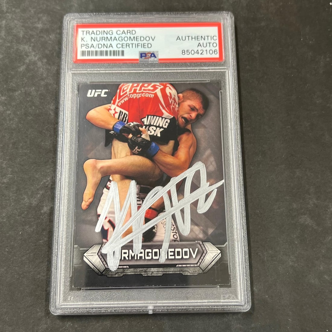 Khabib Nurmagomedov Autographed 2014 Topps 79 UFC Card Authenticated by PSA: Khabib Nurmagomedov Autographed 2014 Topps 79 UFC Card Authenticated by PSA This is a 2014 Topps #79 sports trading card featuring Khabib Nurmagomedov, a prominent athlete in the Ultimate Fighting Cha