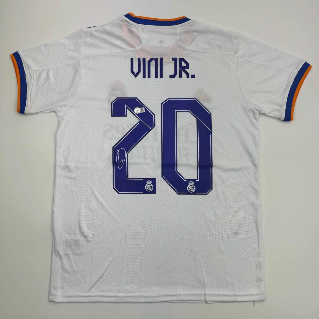Vinicius Jr. Autographed Real Madrid Soccer Jersey Beckett COA: Vinicius Jr. Autographed Real Madrid Soccer Jersey Beckett COA This is an autographed, custom white soccer jersey of Vinicius Jr. from Real Madrid, featuring his name and number. Authenticated by Beck