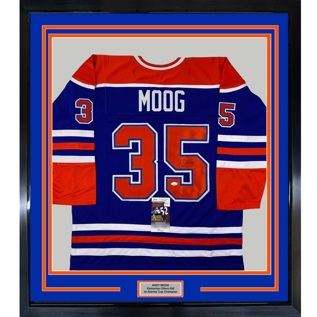 Framed Andy Moog Autographed Edmonton Oilers Jersey with JSA COA: Framed Andy Moog Autographed Edmonton Oilers Jersey with JSA COA This stunning framed autographed Andy Moog jersey showcases the legendary goaltender of the Edmonton Oilers. The item features a vibran