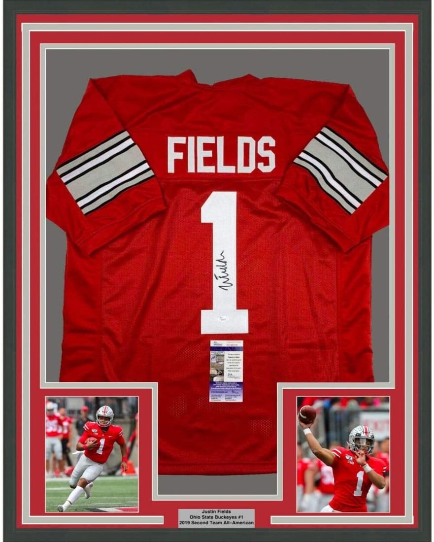 Justin Fields signed Ohio State red jersey framed 35x39 JSA COA: Justin Fields signed Ohio State red jersey framed 35x39 JSA COA This professionally framed display features a red Ohio State Buckeyes jersey autographed by Justin Fields. The jersey is authenticated b