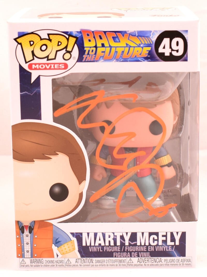 Funko Marty Back to the Future Figure signed by Michael J. Fox JSA Orange: Funko Marty Back to the Future Figure signed by Michael J. Fox JSA Orange Funko Pop figurine #49 featuring Marty in Future, autographed by Michael J. Fox. The item is pre-owned and was made in Vietnam