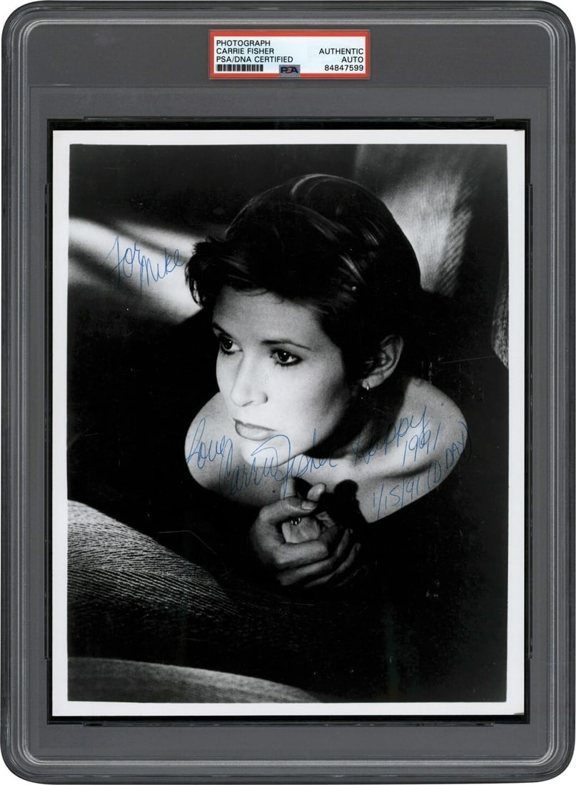 Carrie Fisher Signed 8x10 Photo with PSA DNA Authentication: Carrie Fisher Signed 8x10 Photo with PSA DNA Authentication This stunning 8x10 photograph captures a young Carrie Fisher in a beautiful and haunting noir style. The black and white image features her 