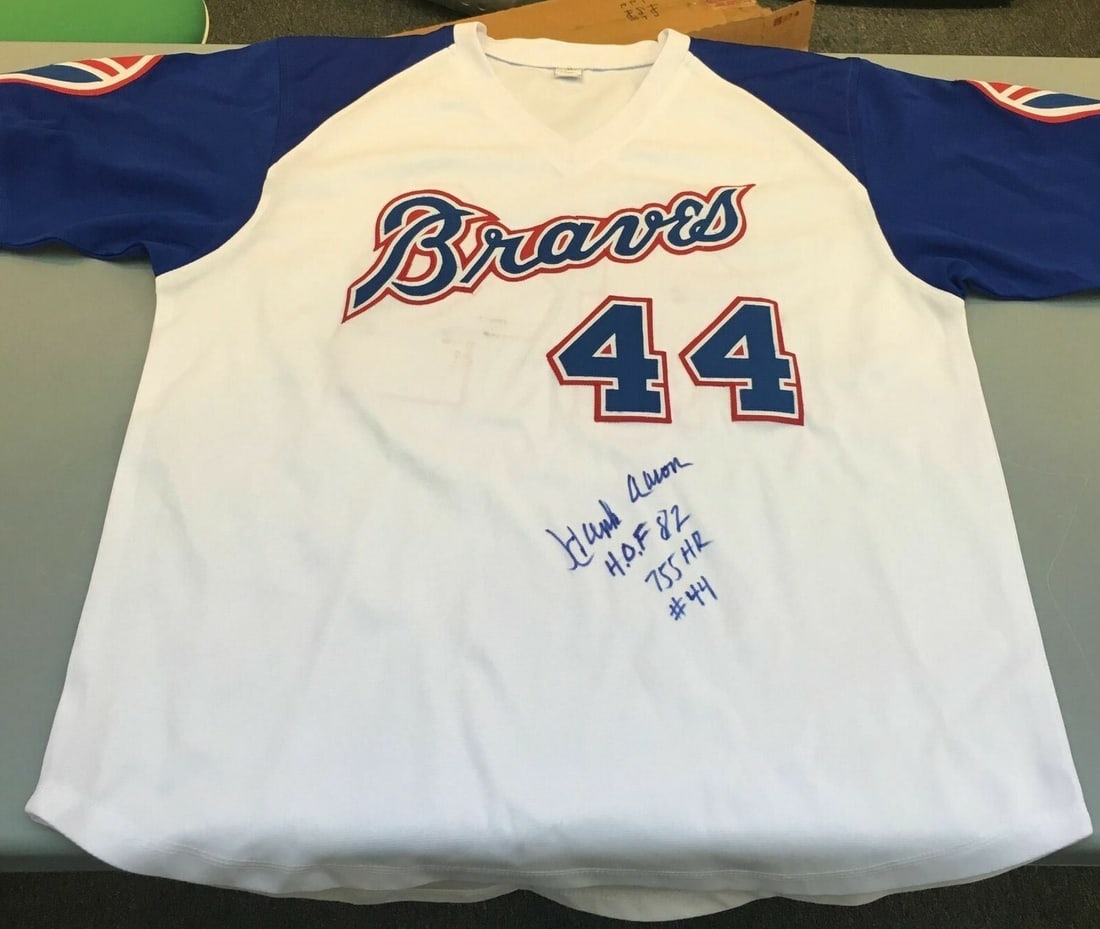 Hank Aaron Atlanta Braves signed inscribed jersey JSA HOF 82 755 HR #44: Hank Aaron Atlanta Braves signed inscribed jersey JSA HOF 82 755 HR #44 This rare Atlanta Braves jersey is signed and heavily inscribed with statistics by Hall of Famer Hank Aaron, featuring his HOF 8
