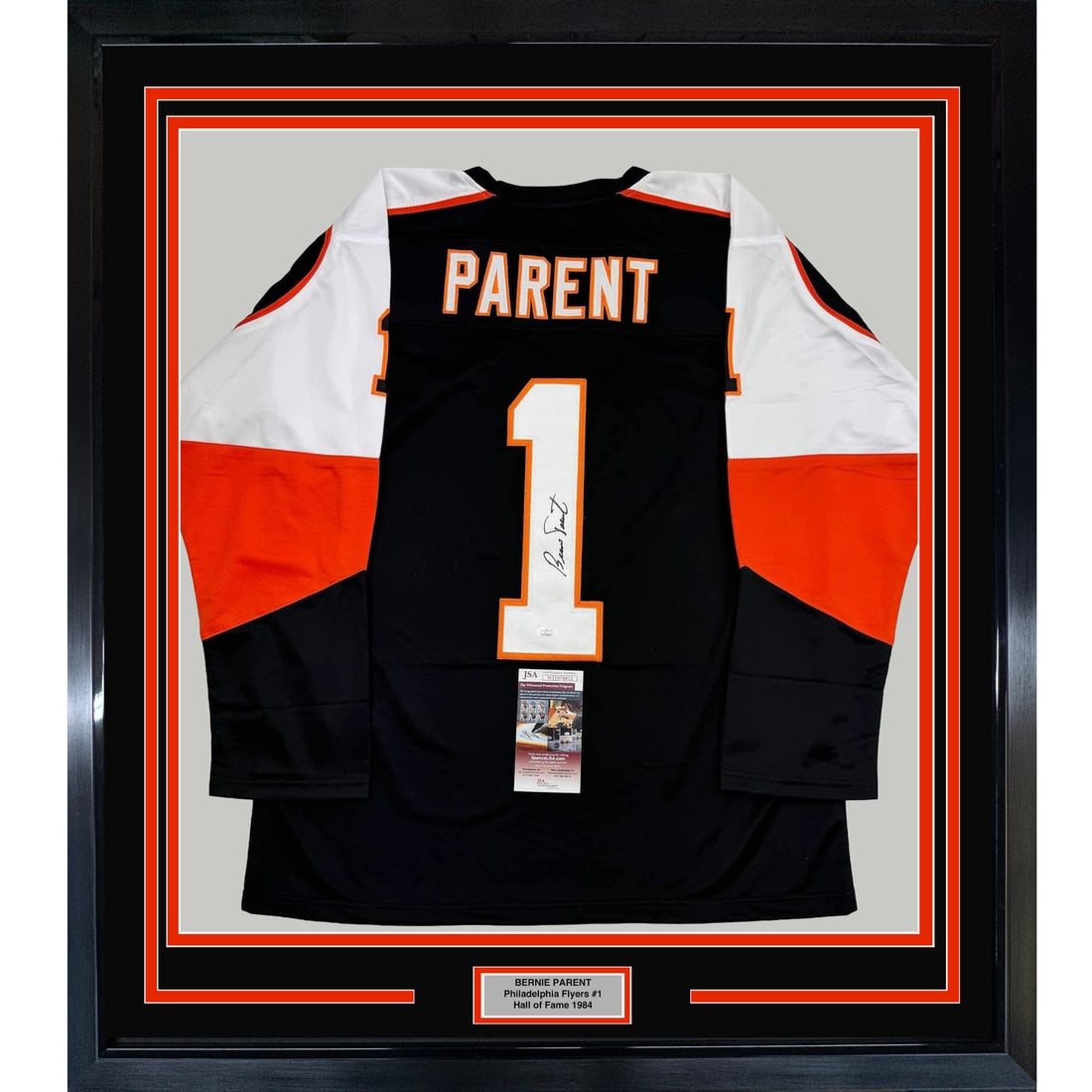 Framed Bernie Parent Signed Black Jersey 35x39 Philadelphia Flyers JSA COA: Framed Bernie Parent Signed Black Jersey 35x39 Philadelphia Flyers JSA COA This professionally framed and matted black jersey features a bold autograph from hockey legend Bernie Parent, a prominent pl