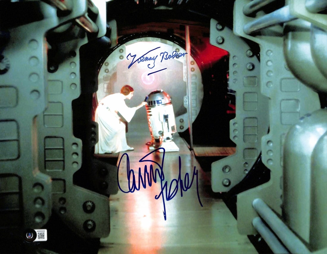 Star Wars 11x14 Photograph Signed by Carrie Fisher and Kenny Baker Beckett LOA: Star Wars 11x14 Photograph Signed by Carrie Fisher and Kenny Baker Beckett LOA This is an original 11x14 inch color photograph from the Star Wars franchise, autographed by Carrie Fisher as Princess Le
