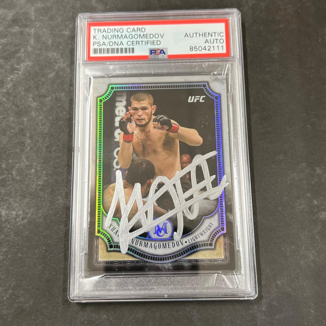 Khabib Nurmagomedov 2018 Topps 18 PSA Autographed Card: Khabib Nurmagomedov 2018 Topps 18 PSA Autographed Card This is a 2018 Topps #18 sports trading card featuring Khabib Nurmagomedov. The card is standard size and has been personally signed by Khabib Nu