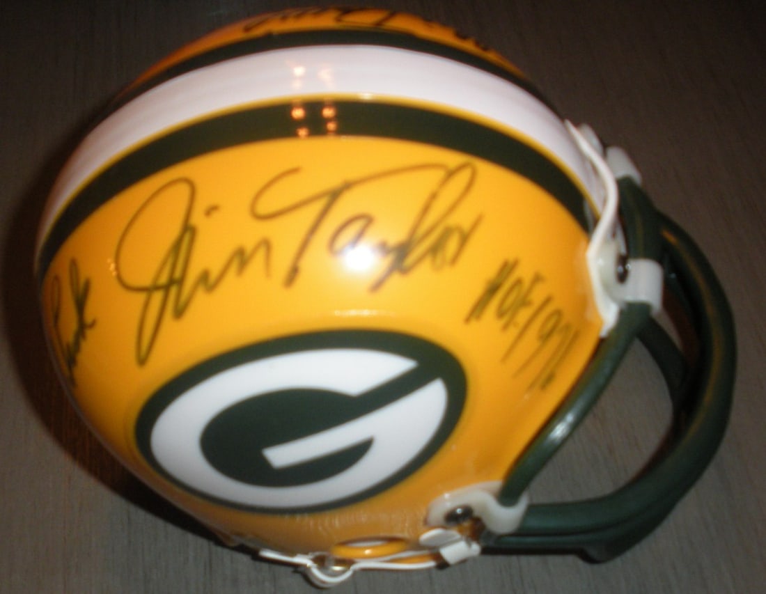 Green Bay Packers mini helmet autographed by Jim Taylor Wood Davis with COA: Green Bay Packers mini helmet autographed by Jim Taylor Wood Davis with COA This Green Bay Packers mini helmet is signed by Jim Taylor, Willie Wood, and Willie Davis. It comes with a Certificate of Au
